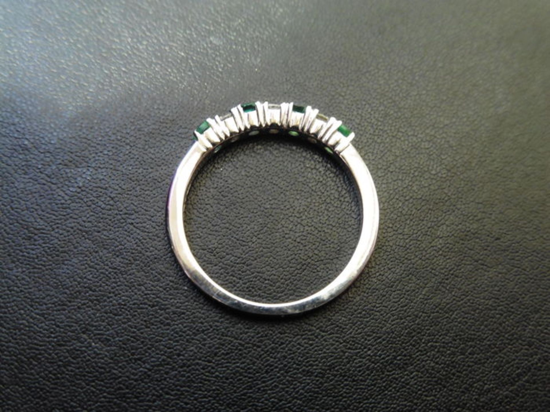 0.40ct emerald and diamond eternity style ring. Set with 4 round cut emeralds and 3 diamonds. Size - Image 2 of 3