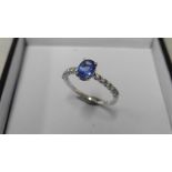 0.80ct / 0.12ct tanzanite and diamond dress ring. Oval cut ( treated ) tanzanite with small diamonds