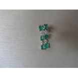 Emerald and diamond drop style earrings set in 18ct gold. Each set with 4 emerald cut ( treated)