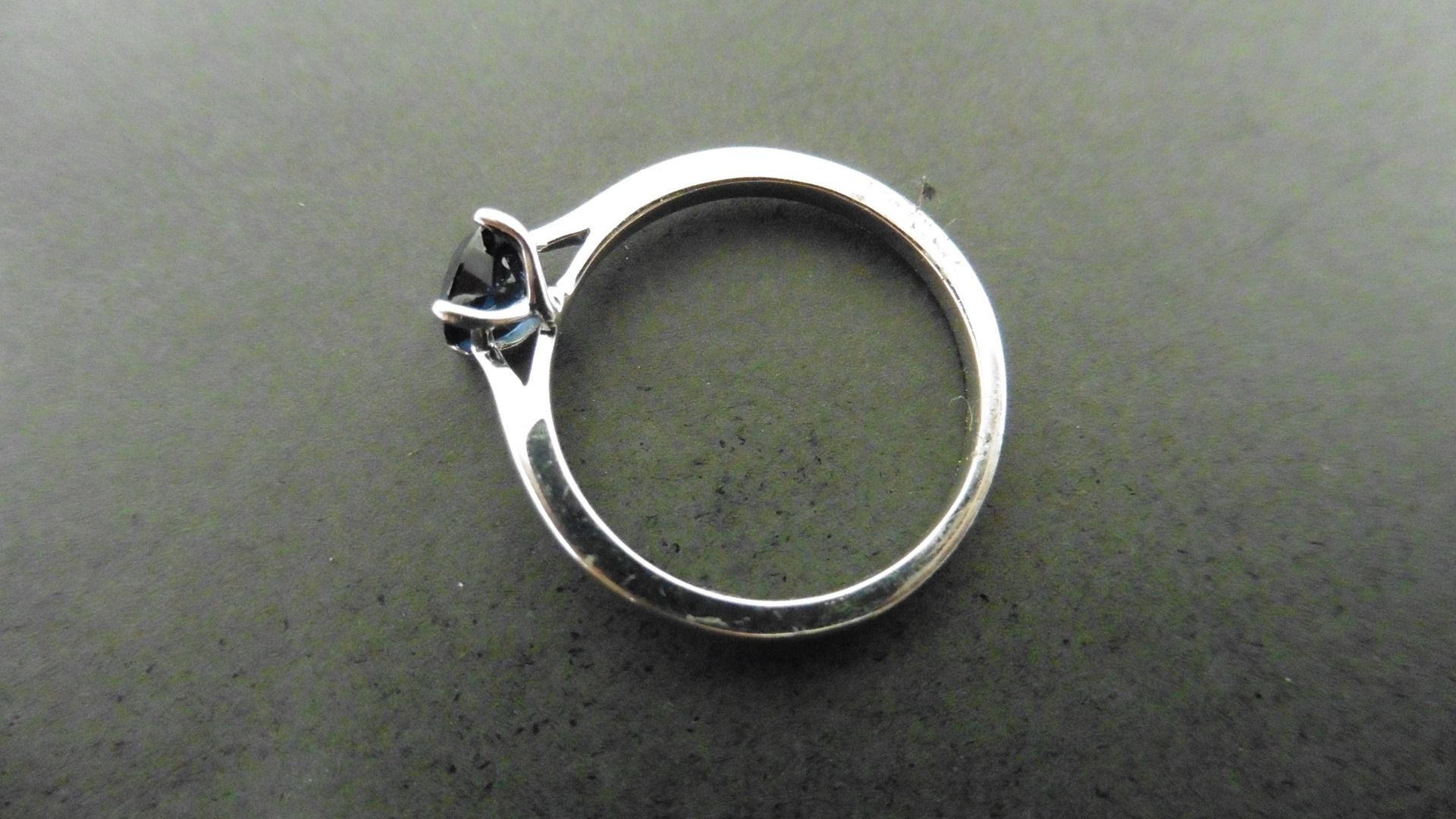 0.50ct solitaire style ring set with a round cut sapphire ( treated ) 5mm. Set in platinum with 4 - Image 2 of 4