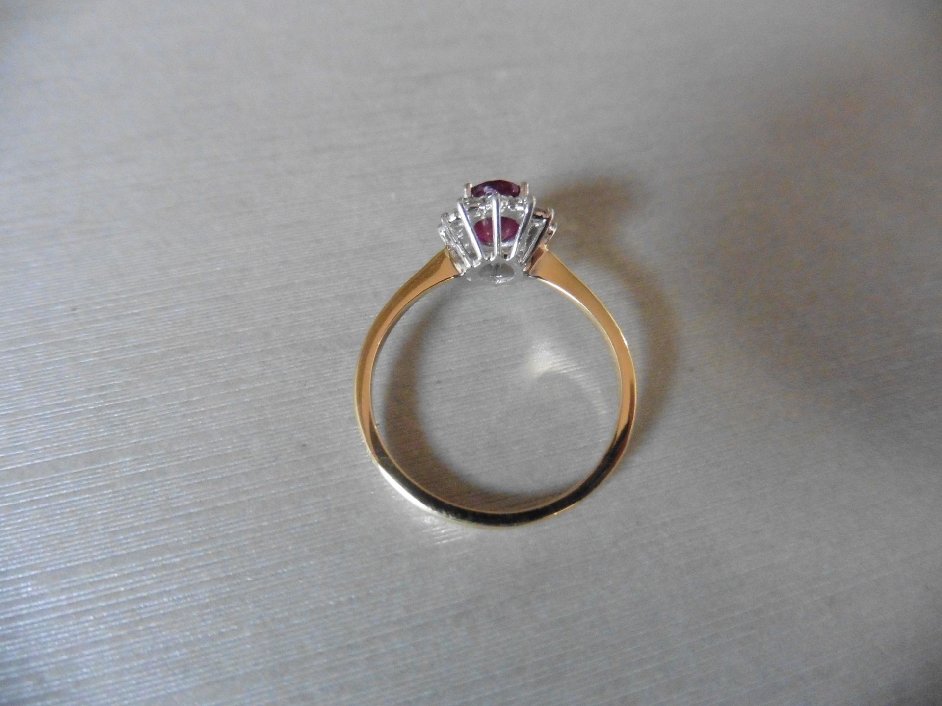 0.75ct / 0.30ct ruby and diamond cluster ring. Oval cut ( glass filled )ruby surrounded by small - Image 3 of 3