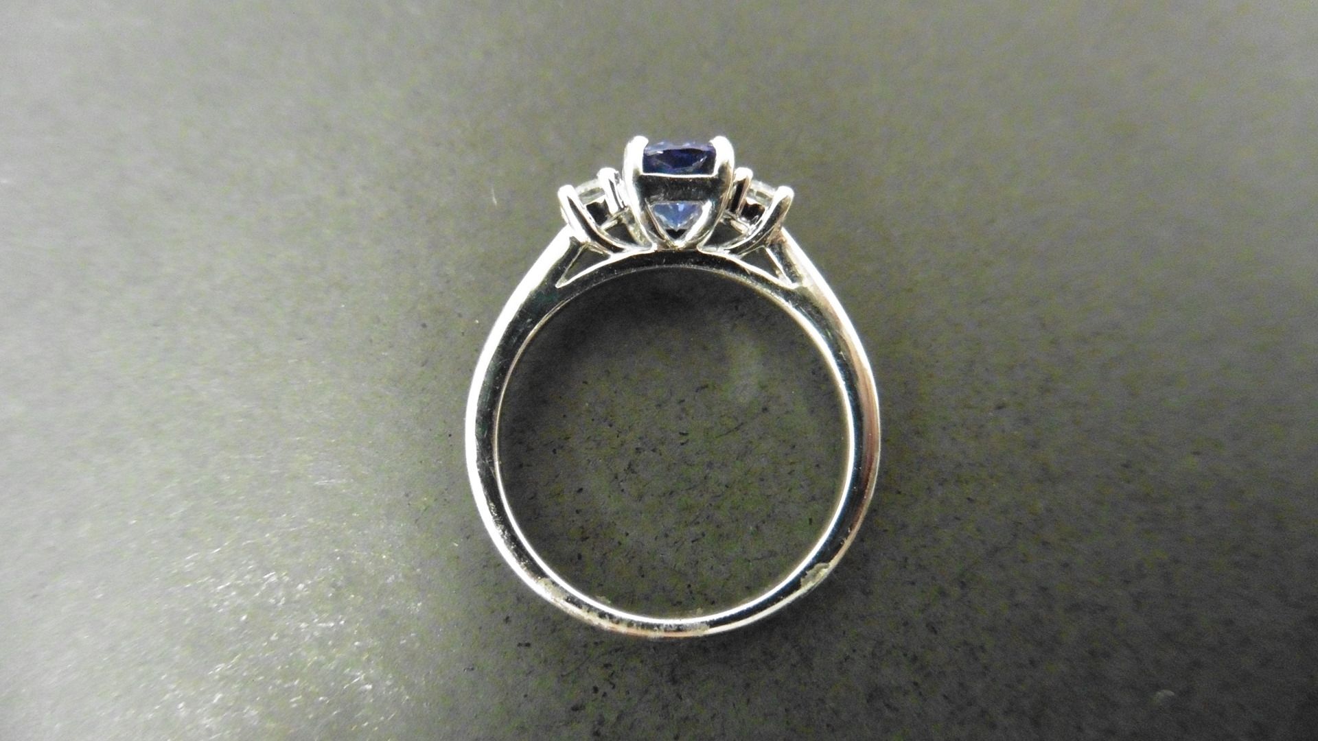 0.80ct tanzanite and diamond trilogy ring. 7x 5mm oval cut tanzanite (treated) with a small - Image 2 of 4