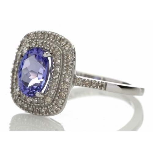 Tanzanite and diamond cluster dress ring set in 14ct gold. 1.29ct Oval cut tanzanite surrounded with - Image 3 of 5