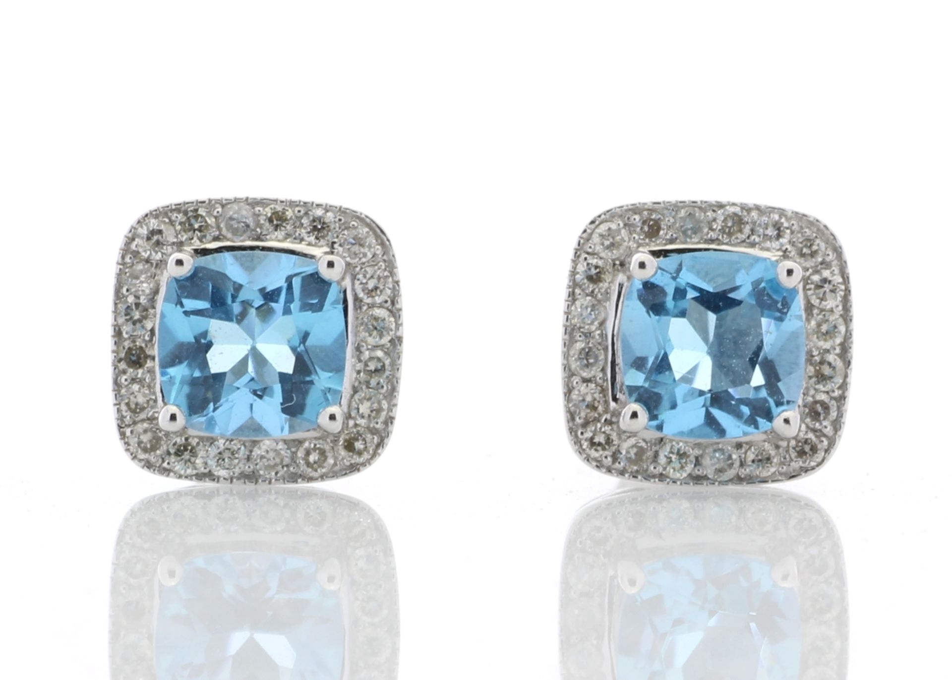 Blue topaz and diamond stud earrings. Cushion cut topaz surrounded by small brilliant cut