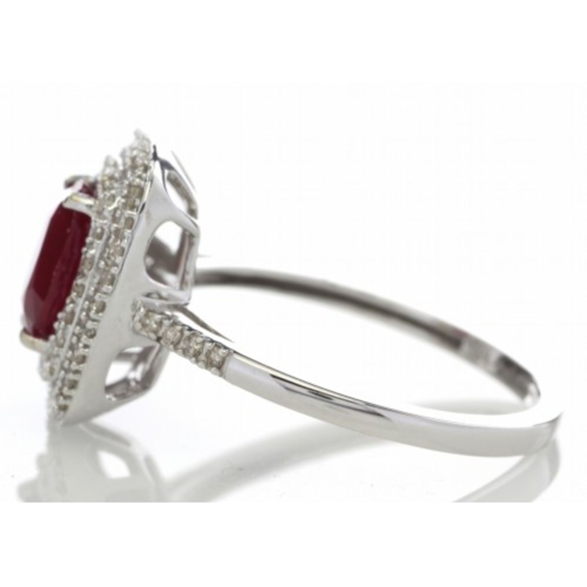 Ruby and diamond cluster dress ring set in 14ct gold. 1.54ct Oval cut ruby surrounded with a - Image 3 of 5