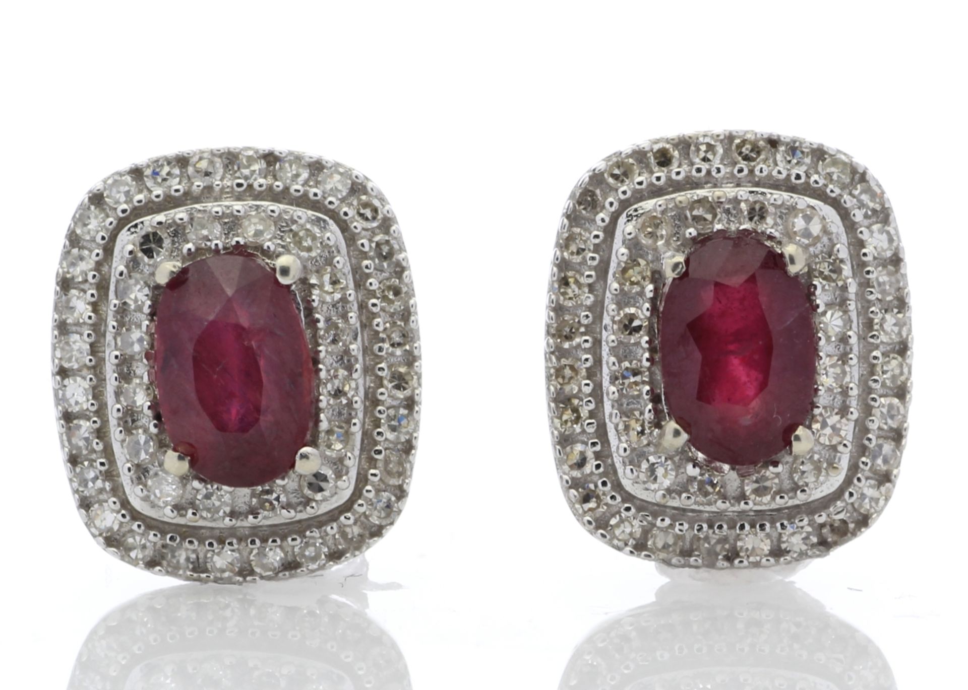 0.80ct ruby and diamond cluster stud earrings. 2 oval cut rubies surrounded with brilliant cut