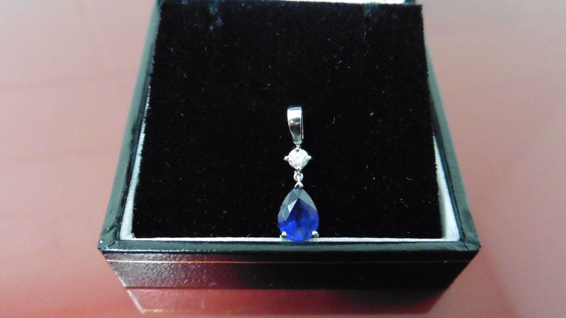 0.35ct sapphire and diamond drop style pendant ( no chain ).Pear shaped sapphire ( glass filled )