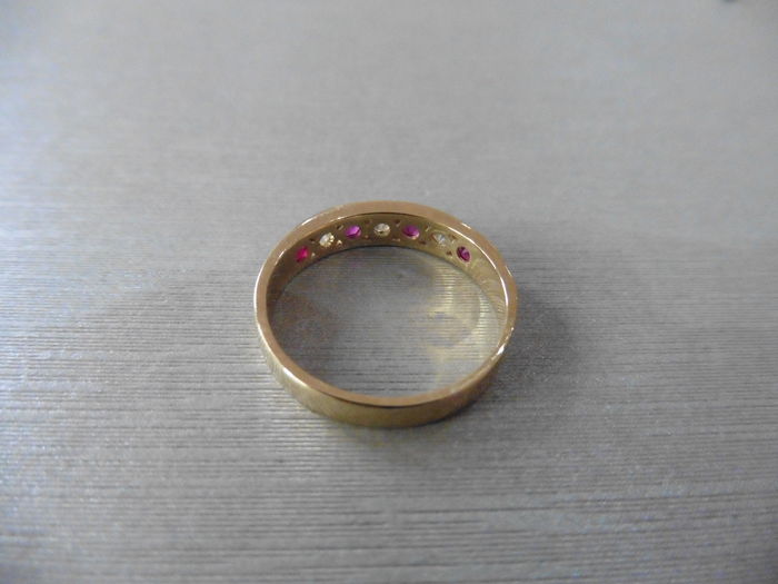 Ruby and diamond eternity band ring set in 9ct yellow gold. 4 small round cut rubies ( treated ) 0. - Image 2 of 2