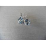 1.60ct Aqua marine and diamond hoop style earrings. Each is set with a 7x 5mm oval cut aqua (