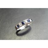 Sapphire and diamond eternity band ring set in 9ct white gold. 4 small round cut sapphires ( treated