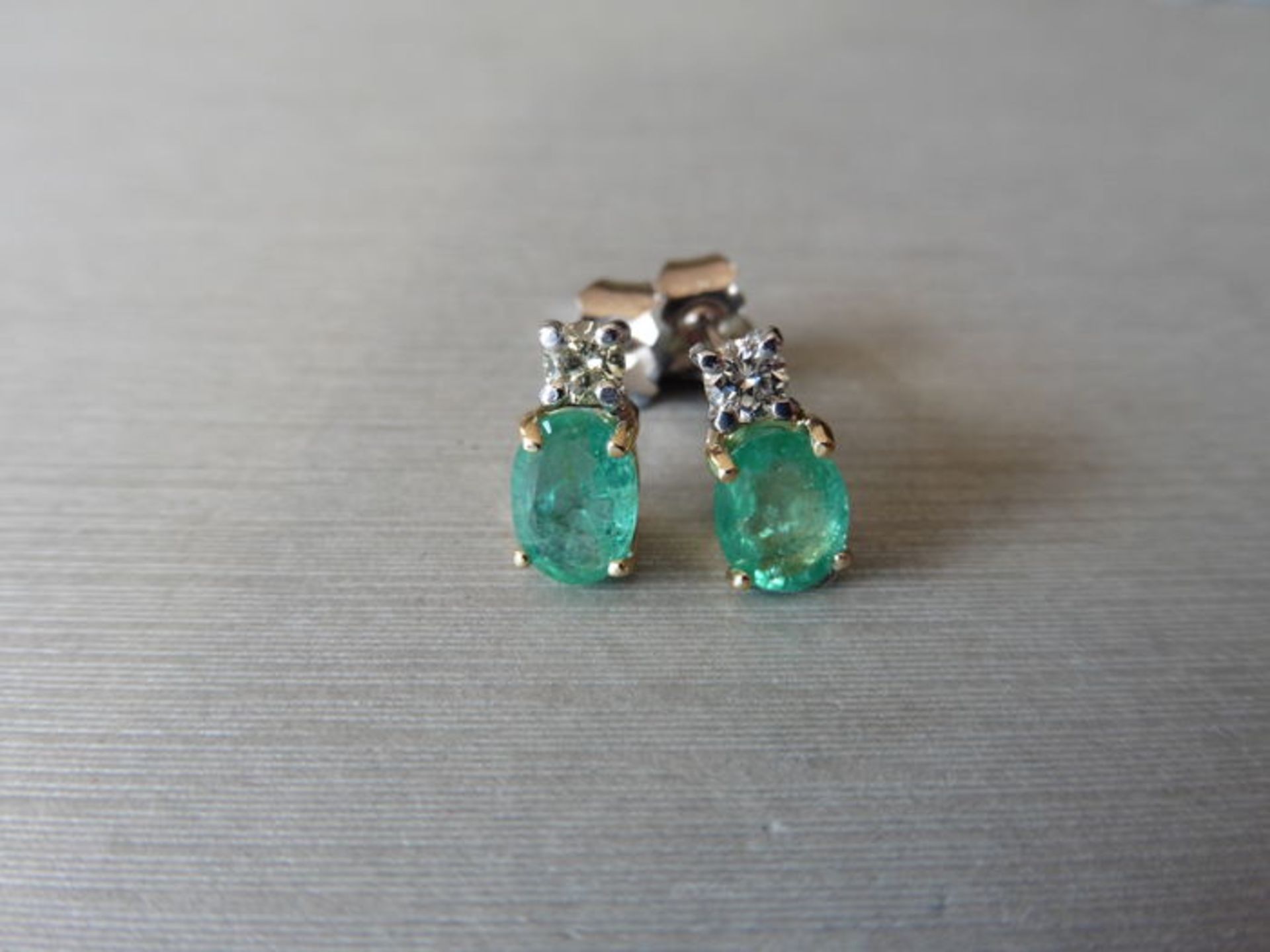 Emerald and Diamond drop earrings. Each set with a 6 x 5mm oval cut emerald ( treated), 1.60ct