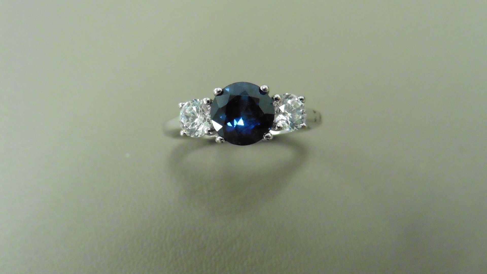 Platinum trilogy style ring. Round cut sapphire, 6mm in the centre (treated) 2 brilliant cut - Image 4 of 4