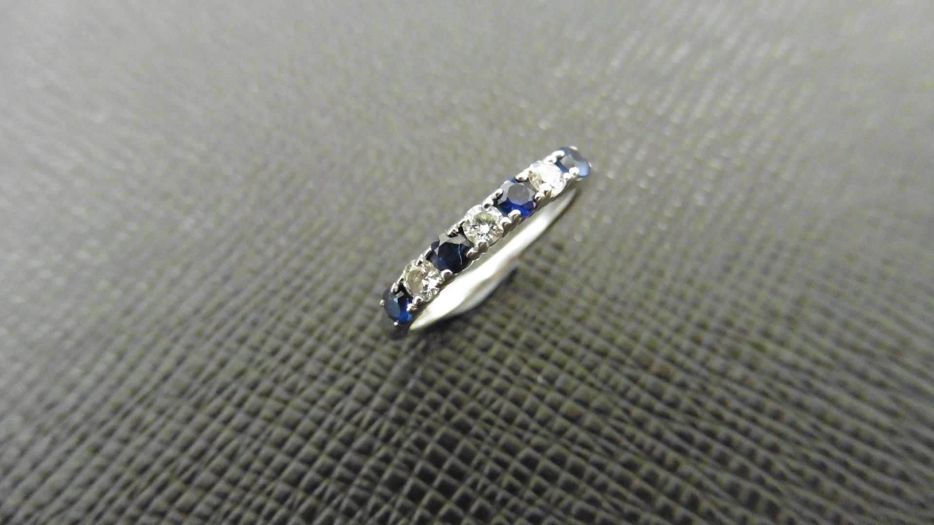 0.40ct sapphire and diamond eternity style ring. Set with 4 round cut sapphires and 3 diamonds. Size