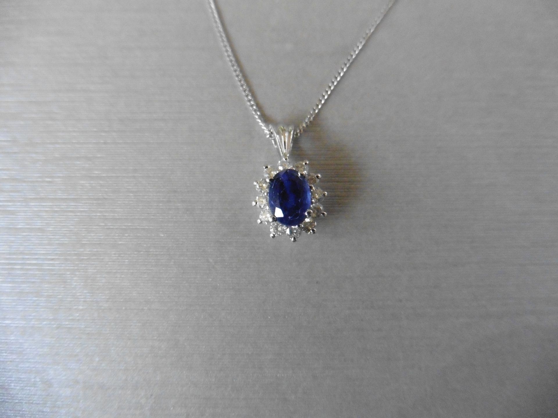 0.80ct sapphire and diamond cluster style pendant. ÊOval cut ( glass filled ) treated sapphire