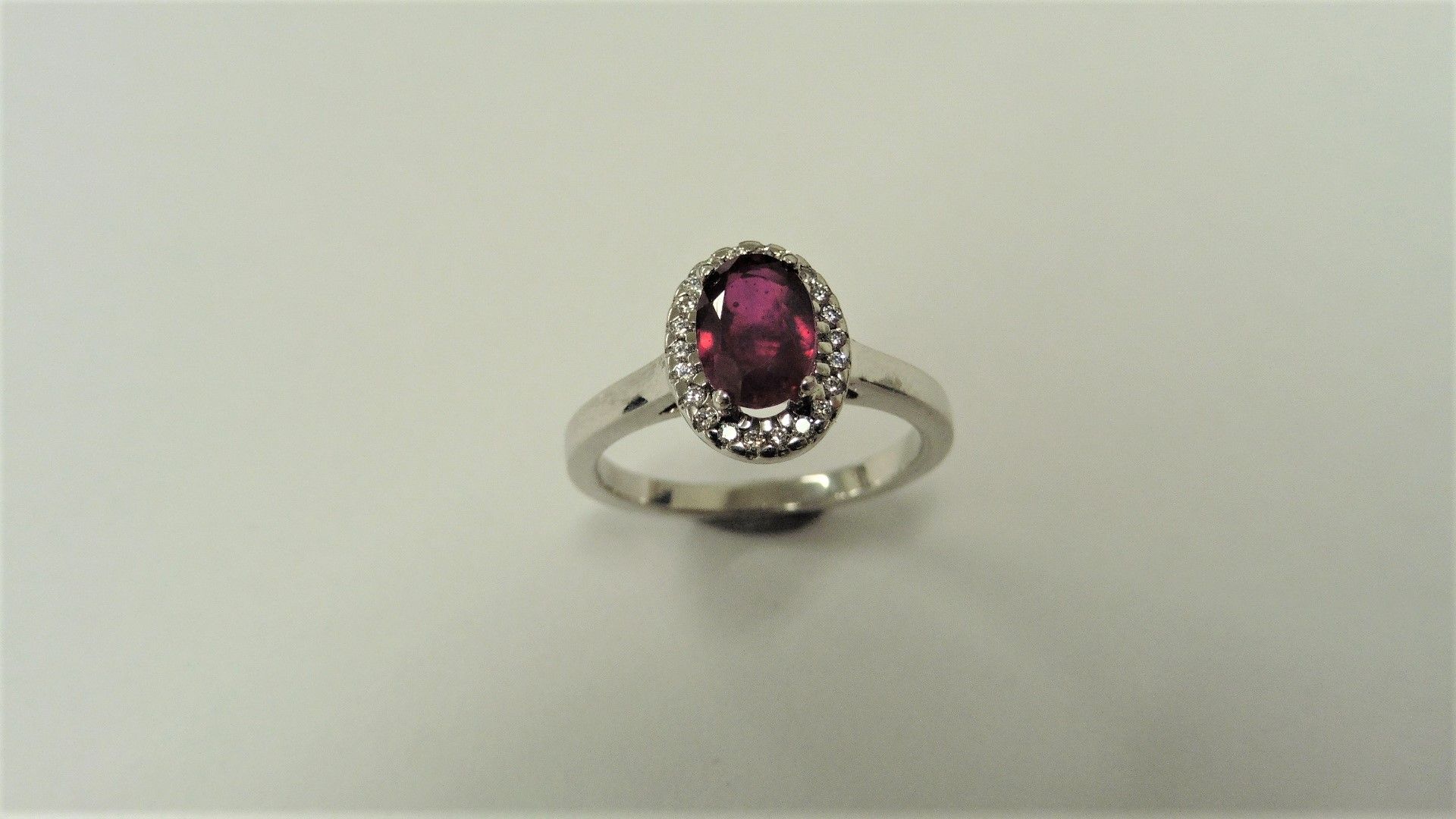 Ruby and Diamond cluster ring set in platinum. Oval cut ruby ( fracture filled ) 1ct, surrounded - Image 3 of 3