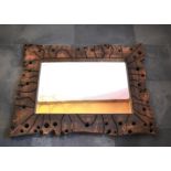 Malcom Lewis | This is an elm Swiss jigsaw mirror with copper stitching and measures 85cm x 110cm