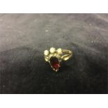 A ruby and seed pearl ring in a 9ct gold setting