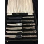 A boxed set of silver handed butter knives