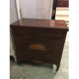A Biedermeier mahogany petite commode circa 1810. Crossbanded top above three graduated drawers, the