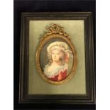 A 19th Century miniature of Marie Antoinette in a scrolled metal frame, framed on a velvet mount and
