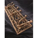 A cast iron triple tool or coat hanger