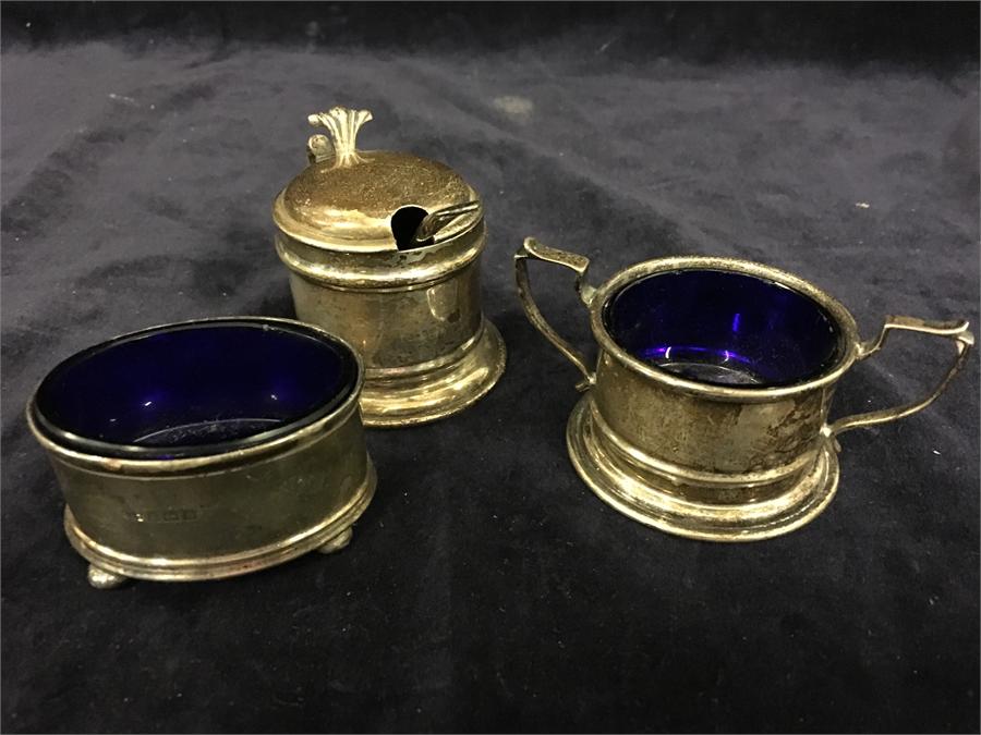 Silver cruets with blue glass liners