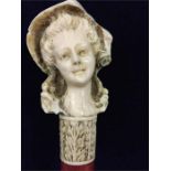 An 18th Century Malacca cane with carved ivory handle of a lady (Damage to the hat)