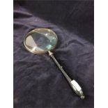 A silver plate 6" magnifying glass