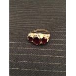 A Three stone garnet ring on 9ct gold (4.1g total weight)