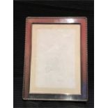 A hallmarked silver photograph frame