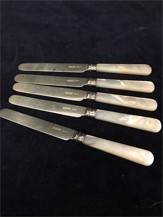 Five silver and pearl handled knives