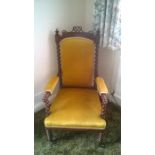 A Victorian chair on front castors with mustard upholstery