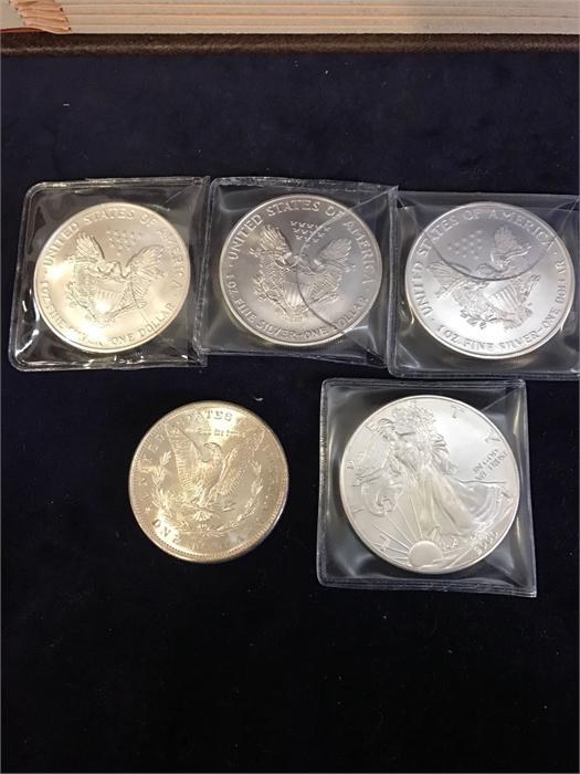 Five American silver dollars, various years