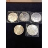 Five American silver dollars, various years
