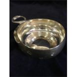 A silver bowl with serpent designed handle