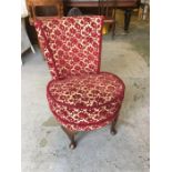 A red and cream floral design nursing chair