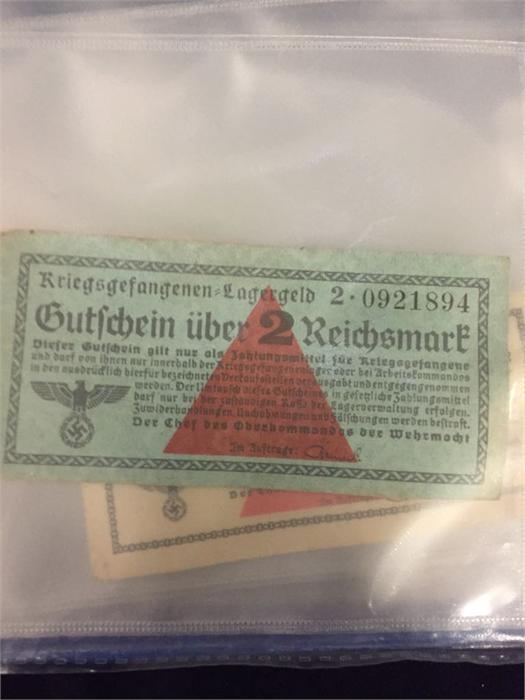 A folder of World War II German Prisoner of War money