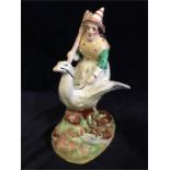 A Staffordshire figure of a witch riding a goose