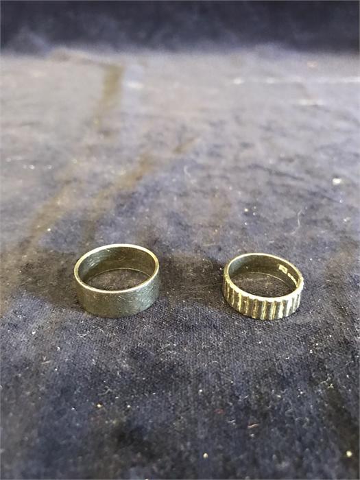 A 18ct gold hallmarked ring (5.5g) and another hallmarked gold wedding ring (6.7g)