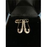 A pair of 18ct gold and pave diamond safety pin earrings, left and right, by Anita Ko along with