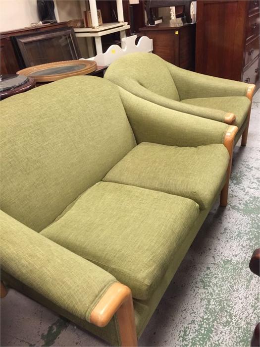 A mid century two seater sofa and arm chair