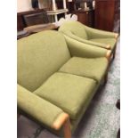 A mid century two seater sofa and arm chair