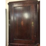 A mahogany corner cabinet with inlay