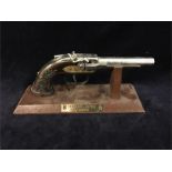 A mounted antique pistol lighter