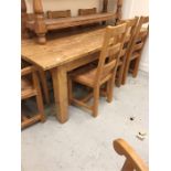 A Pine Dining table with two carvers and six chairs with rush seats 2.15 m x 85cm