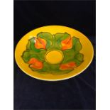 A Poole pottery Aegean large bowl, with yellow glaze and green and orange geometric flower