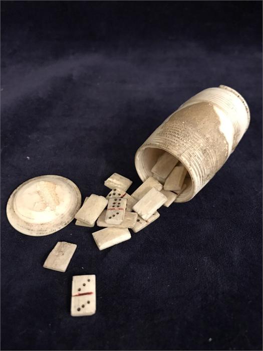 A set of Napoleonic Prisoner-of-War carved bone miniature dominoes in turned barrel-form case (