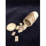 A set of Napoleonic Prisoner-of-War carved bone miniature dominoes in turned barrel-form case (