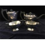 A silver tea set comprising Teapot, sugar bowl and milk jug hallmarked Birmingham and hot water