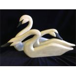 Three wooden decorative swans